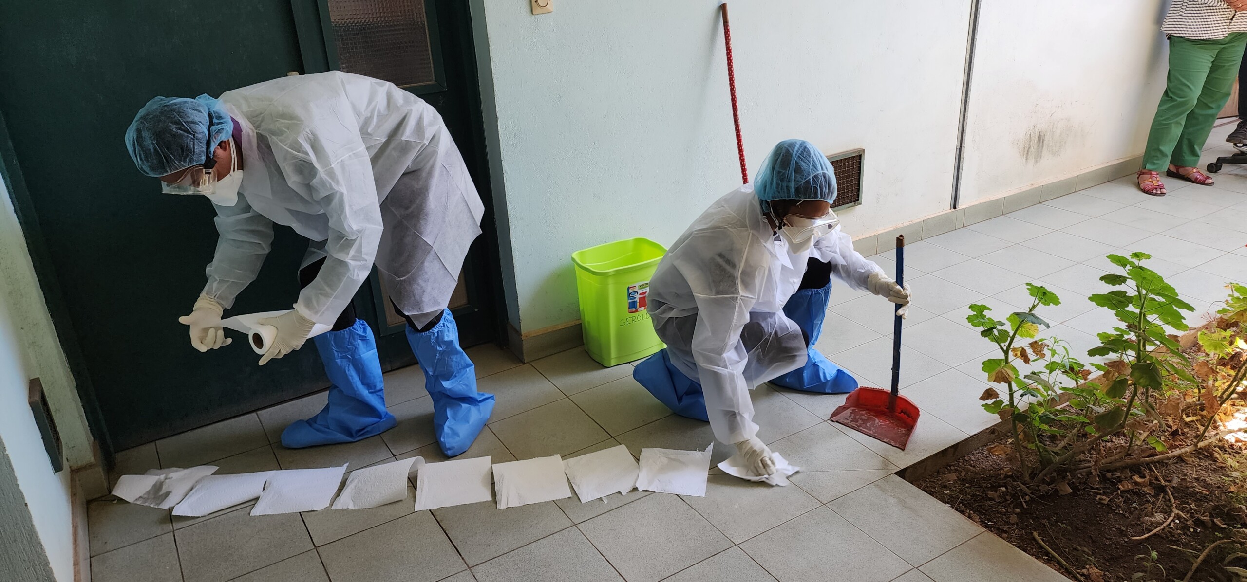 Drs. Toky Ramilijohn and Hoby Andriamampianina demonstrate how to clean up a laboratory spillage